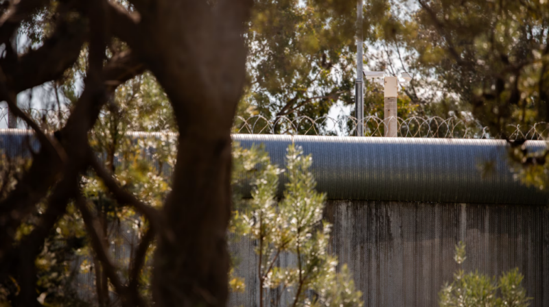 CCTV cameras seen over the fence of Banksia Hill Detention Centre. ABC News: Keane Bourke