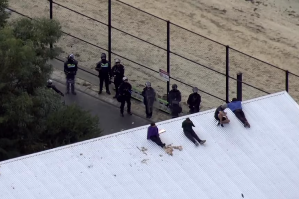 A group of detainees on a roof at Banksia Hill in 2023 after a riot saw armed officers called to the facility. (ABC News)