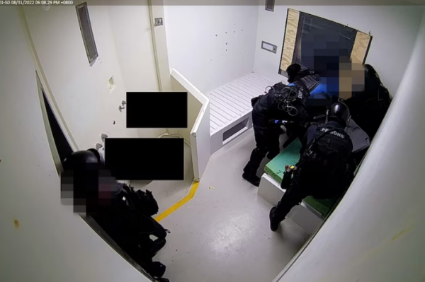 A teenage detainee being restrained by guards in Unit 18, a youth wing at the Casuarina adult prison. (Supplied)