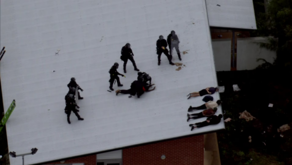 Officers in riot gear put restraints on the detainees, who were on the roof of Banksia Hill. ABC News